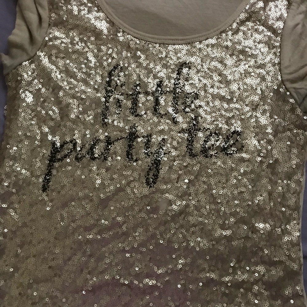 A cream and gold short sleeved shirt